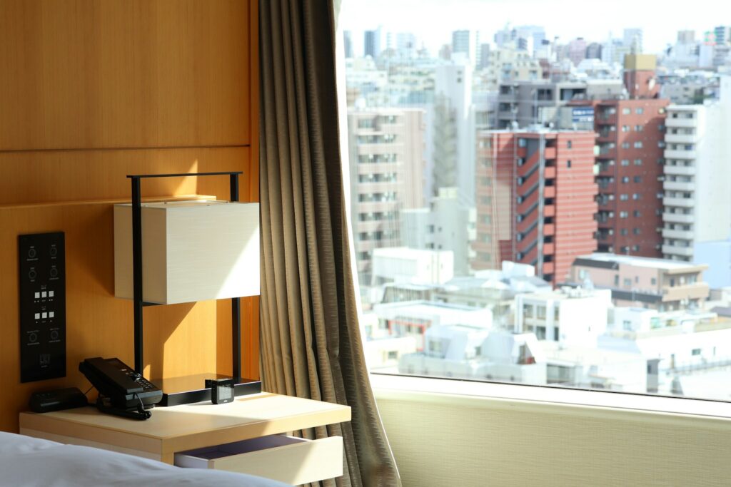 A bright hotel room overlooking the Tokyo cityscape — a typical view for families staying in central Tokyo