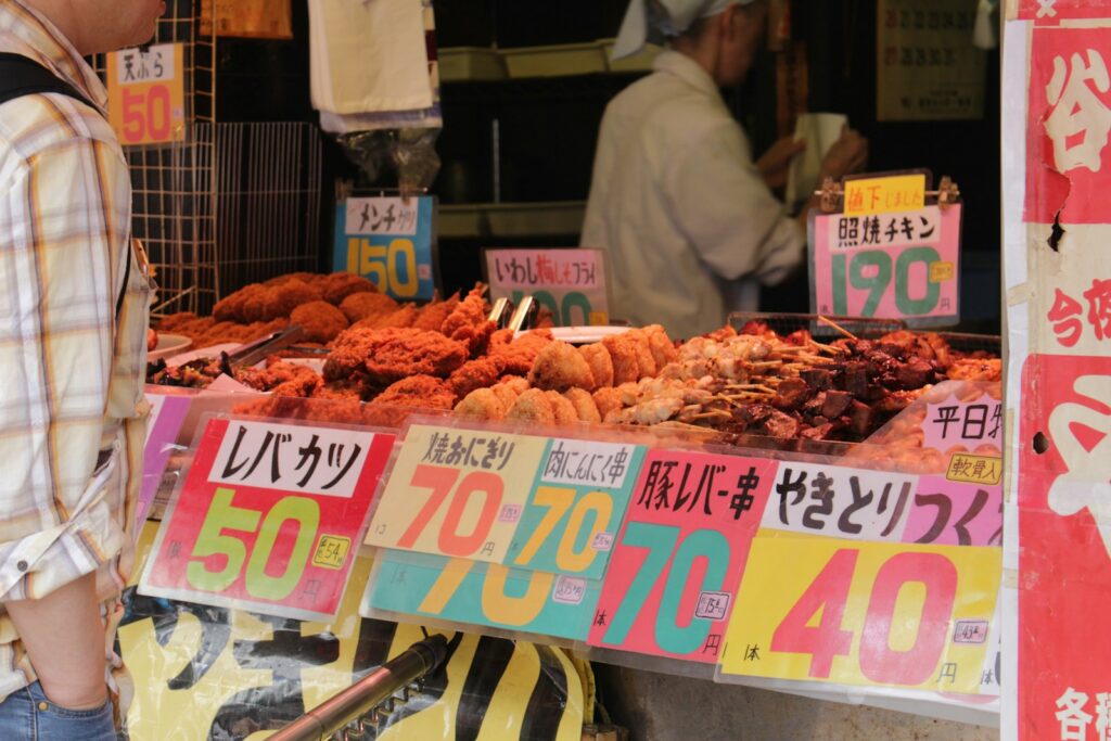 Colorful food market stall in Tokyo with assorted dishes on display