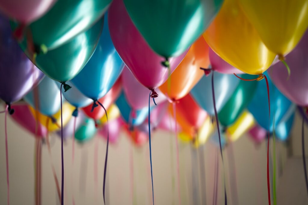 Colorful pastel balloons, evoking a fun family theme park visit