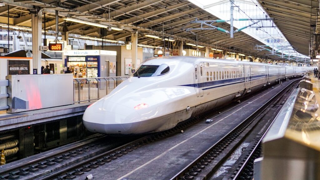 Shinkansen bullet train pulling into a station platform in Japan