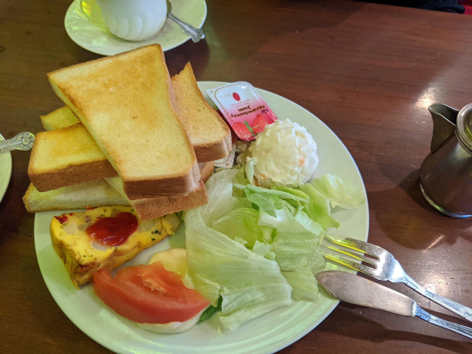 A classic Japanese kissaten morning set with toast, egg, and salad.