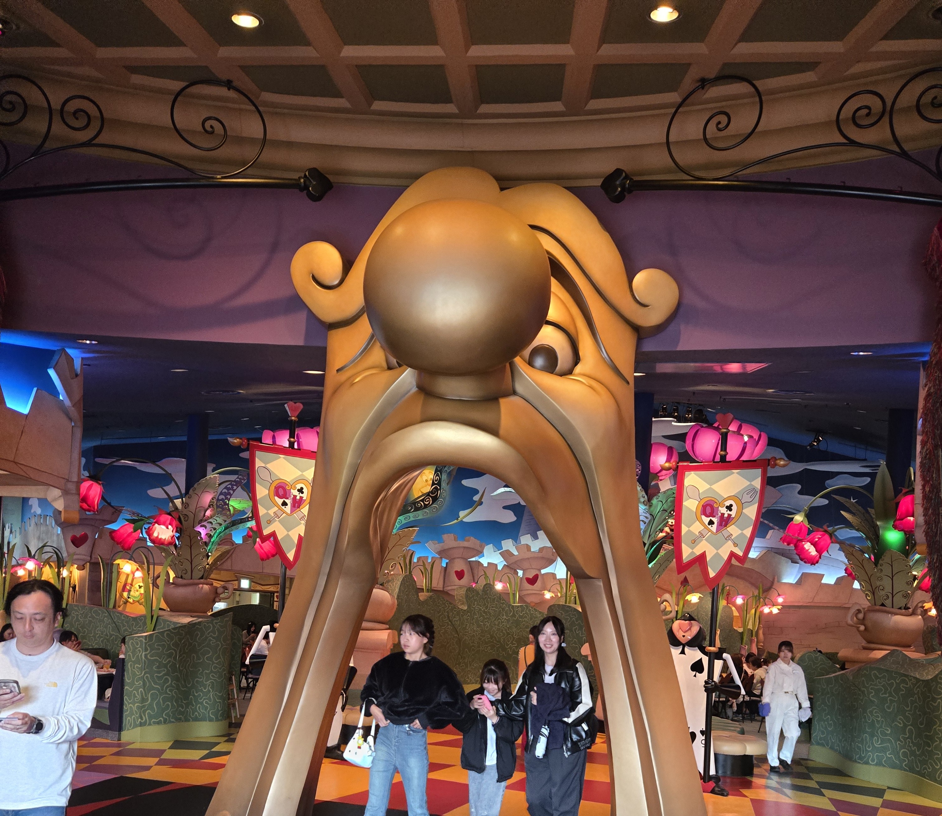 The golden mask-shaped entrance archway to Queen of Hearts Banquet Hall at Tokyo Disneyland.