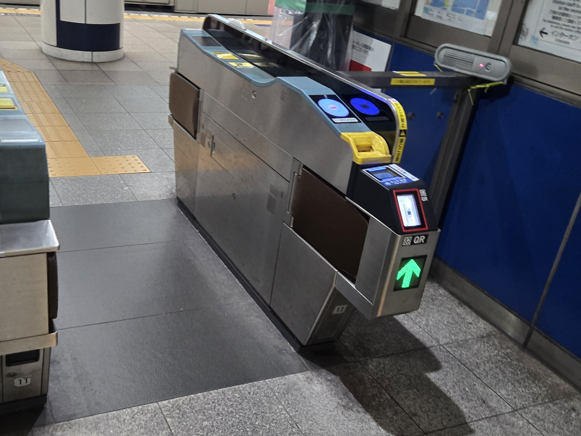 A Tokyo subway ticket gate with both IC card and QR code readers.